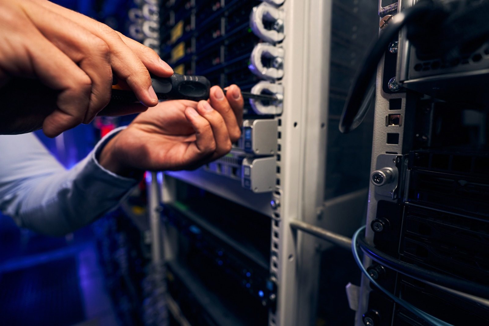 Technician installing and supporting hardware on site